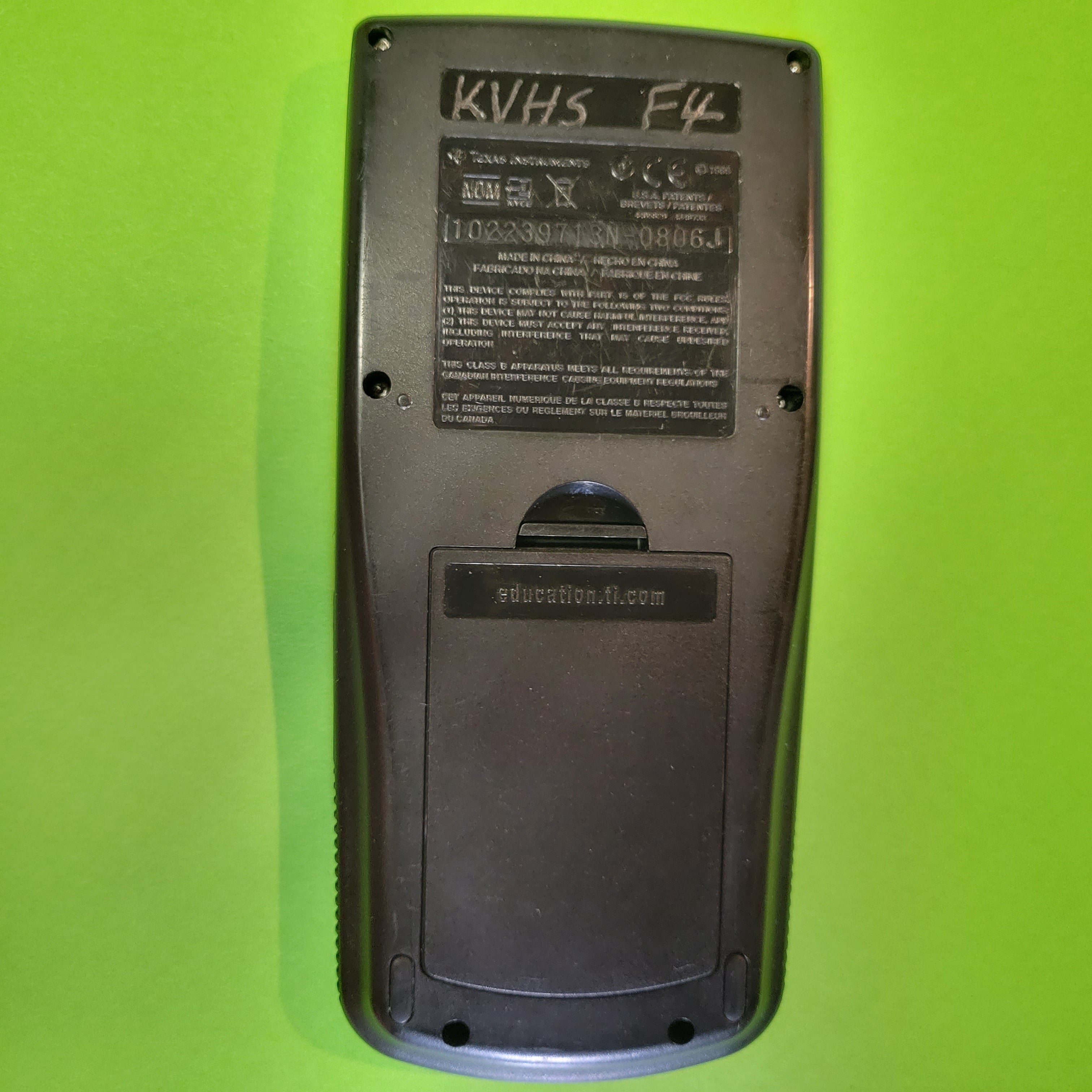 An image of the back of a texas instruments ti83 plus graphing calculator